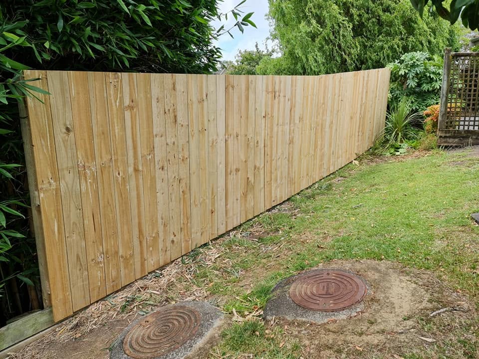 New timber paling fence built along a back garden boundary