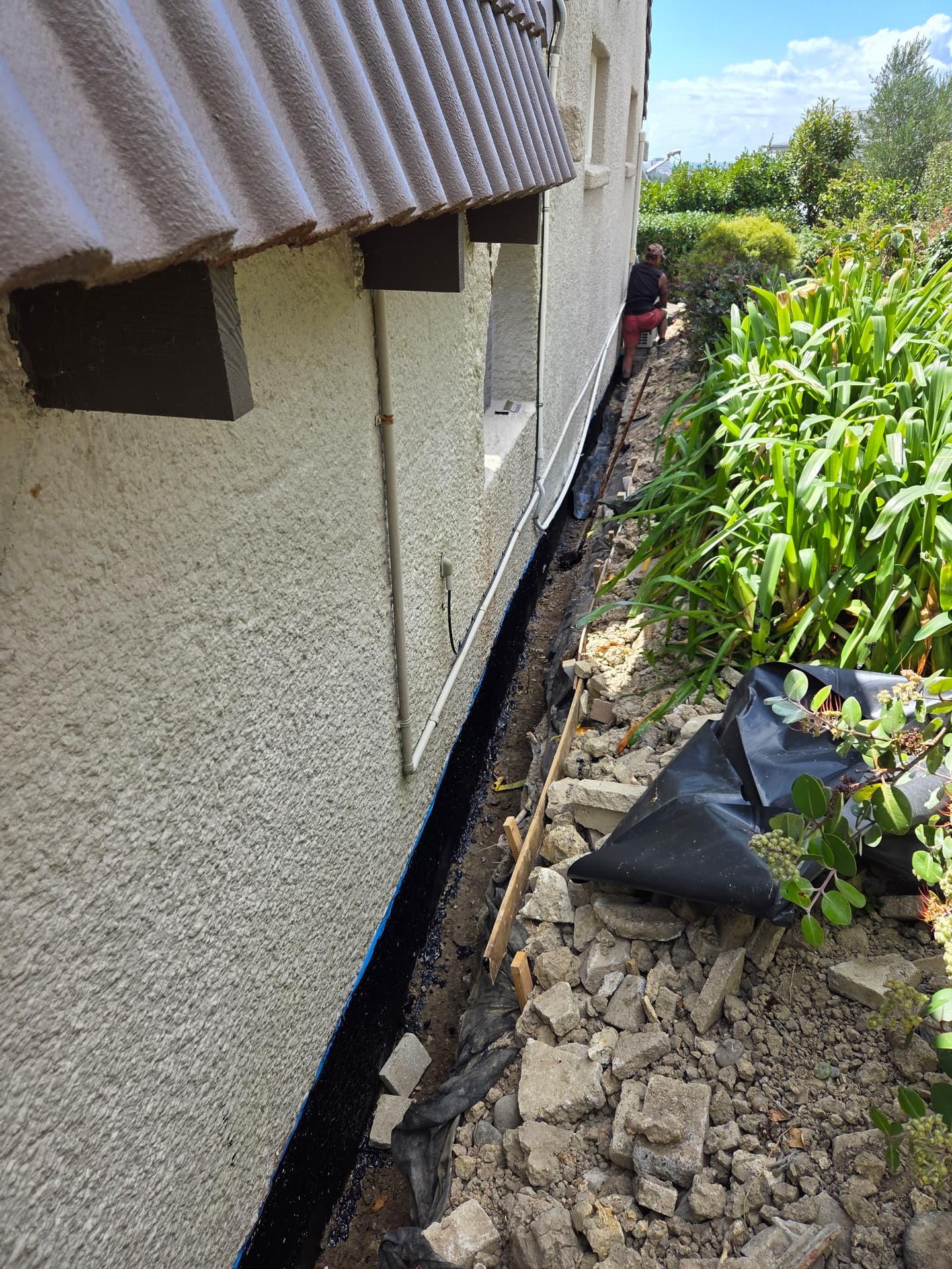 Trench dug along a house foundation for waterproofing