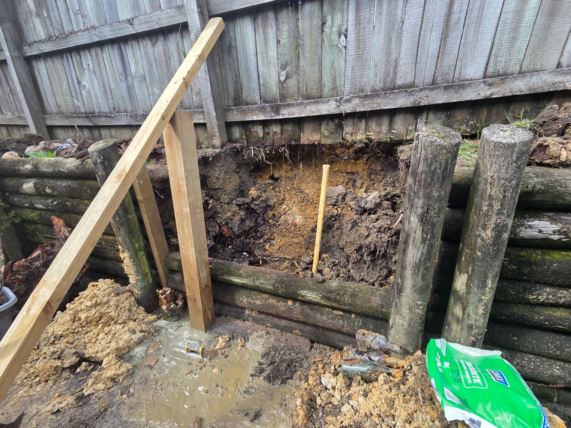 Timber retaining wall being repaired and braced